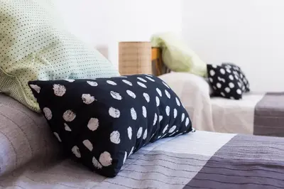 a black and white pillow sitting on a couch at Casa Valle del Turia in Chulilla