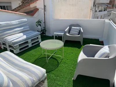 a balcony with a table and chairs and grass at Casa Valle del Turia in Chulilla