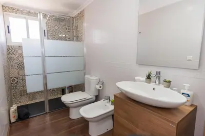 a bathroom with a sink and a toilet and a shower at Duplex Penthouse with terrace. Beach-Pool in Canet de Berenguer