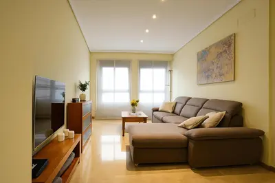 a living room with a couch and a tv at City Center Apartment in Valencia
