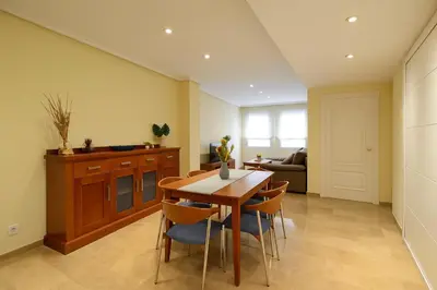 a kitchen and dining room with a table and chairs at City Center Apartment in Valencia