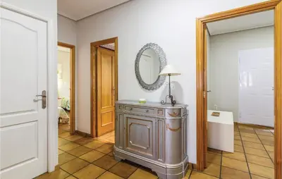 a room with a table and a mirror on the wall at 2 Bedroom Cozy Home In Faro De Cullera in Faro de Cullera