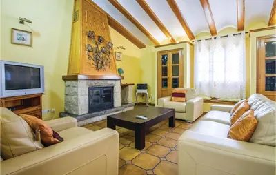 a living room with two couches and a fireplace at 2 Bedroom Cozy Home In Faro De Cullera in Faro de Cullera