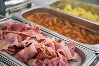 a pile of meat and other food items in trays at Casual Socarrat Valencia - Adults Only in Valencia