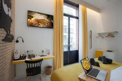 a room with a desk and a laptop on a table at Casual Socarrat Valencia - Adults Only in Valencia