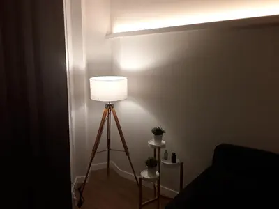 a lamp in the corner of a room with a light at SLEEP TURIA LLIRIA in Lliria