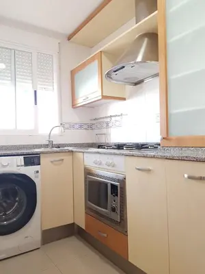 a kitchen with a washing machine and a washer at Moncofa Beach in Moncófar