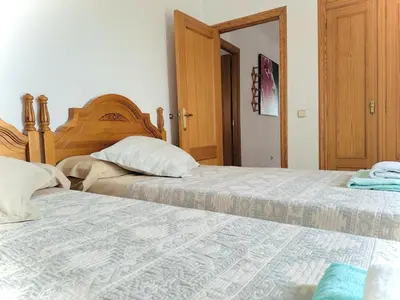 two beds sitting next to each other in a bedroom at Valencia Sol y Playa in Sagunto