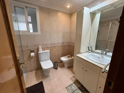 a bathroom with a toilet and a sink and a mirror at Moderno y acogedor apartamento para 6 personas in Valencia
