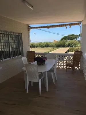 a white table and chairs on a patio at Casa Ferrada in Burriana