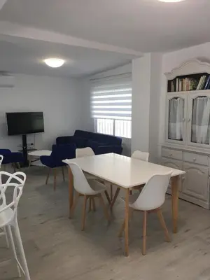 a living room with a white table and chairs at Casa Ferrada in Burriana