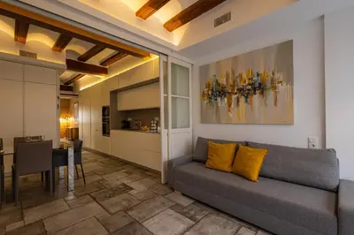 a living room with a couch and a dining room at FLORIT FLATS - CENTER MODERN 1BR 2Bth TERRACE WI-FI AC in Valencia
