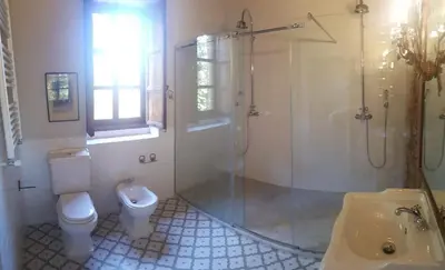 a bathroom with a toilet and a shower and a sink at Alquería Calatrava B&B in Burriana