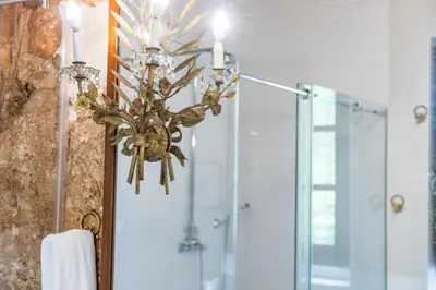 a chandelier in a bathroom with a shower at Alquería Calatrava B&B in Burriana
