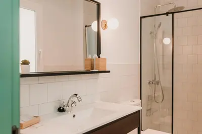 a white bathroom with a sink and a shower at Lindala in Valencia