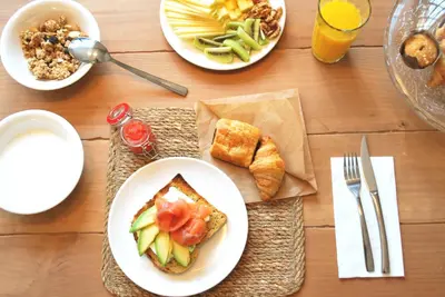 a wooden table with plates of food on it at Lindala in Valencia