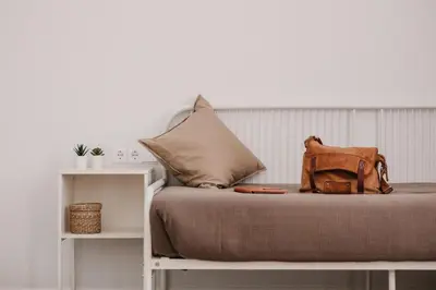 a bed with a brown bag on top of it at Lindala in Valencia