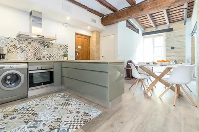 a kitchen with a washer and dryer and a table at FLORIT FLATS - CATHEDRAL LUXURY TERRACE FLAT 2BR 2BA AC Wifi in Valencia