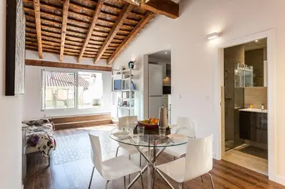 a dining room with a glass table and white chairs at FLORIT FLATS - CENTER 2BR 2BA ATTIC TERRACE VIEW WIFi AC in Valencia