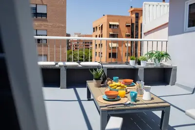 a table on a balcony with fruit on it at FLORIT FLATS - Cabanyal 3 Bedroom WIFI AC Terrace Beach Penthouse in Valencia