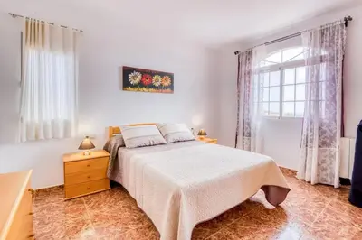 a bedroom with a large bed and a window at Family Villa in Benifayó with Year-Round Private Pool in Benifayó
