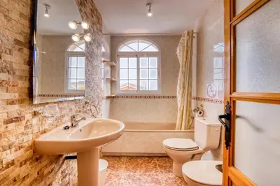 a bathroom with a sink and a toilet and a tub at Family Villa in Benifayó with Year-Round Private Pool in Benifayó