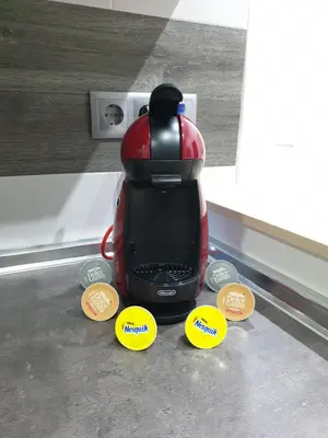 a red blender sitting on top of a counter next tocoins at Bioparc Metro Valencia in Valencia