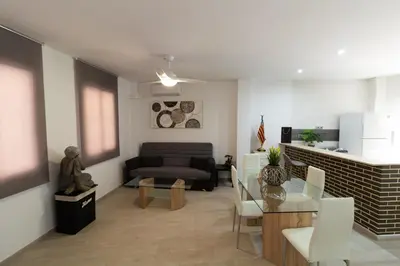a living room with a couch and a table at Bioparc Metro Valencia in Valencia
