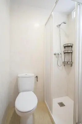 a white bathroom with a toilet and a shower at Ideally Located Holiday Apartment in Moncófar
