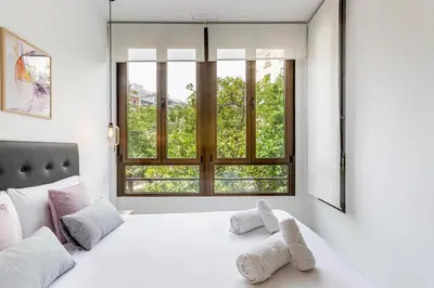a bedroom with a white bed and a window at G&V APARTMENTS CLOSE to CENTER in Valencia