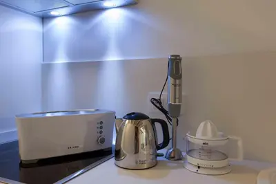 a kitchen counter with a coffee maker and a toaster at ApartUP Central Market I in Valencia