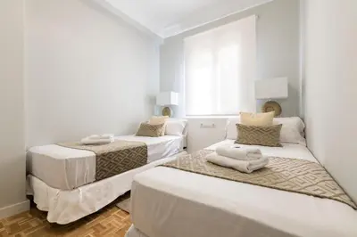 two beds in a room with white walls at MD Pasaje Ruzafa in Valencia