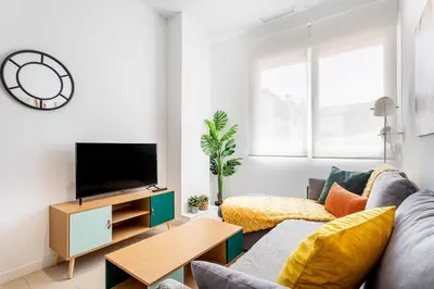 a living room with a couch and a tv at R&C APARTMENTS CLOSE to CENTER in Valencia