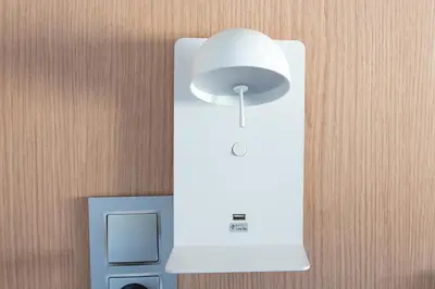 a white light on a wall next to a speaker at Olympia Consul del Mar in Valencia