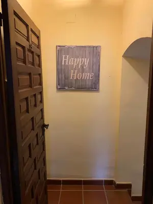 a happy home sign on a wall next to a door at Castillo con piscina en plena Sierra Calderona in Segorbe
