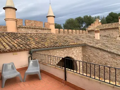 two chairs sitting on a balcony of a castle at Castillo con piscina en plena Sierra Calderona in Segorbe