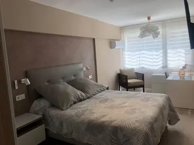 a bedroom with a bed and a desk and a window at Betero Beach & City in Valencia