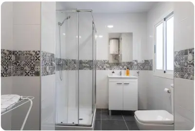 a bathroom with a shower and a toilet and a sink at Islas Canarias Apartment in Valencia