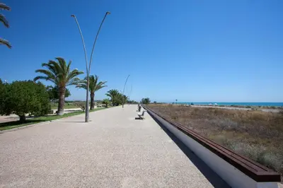 a sidewalk next to the beach with a street light at SingularStays Moncofar Beach in Moncófar