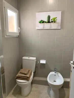 a bathroom with a toilet and a sink at Slow Room Valencia in Valencia