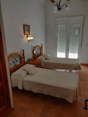 a room with three beds and a window at Casa Josefina in Yátova