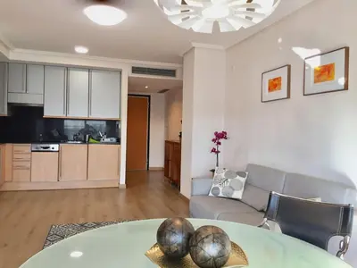 a living room with a table and a couch and a kitchen at Loft en la Ciudad de las Ciencias y cerca de la playa in Valencia