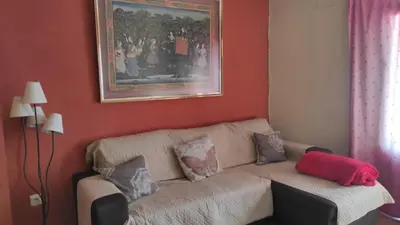 a living room with a couch with pillows on it at La Media Luna in Segorbe