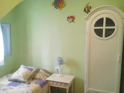 a bedroom with a bed and a table with a lamp at La Media Luna in Segorbe