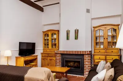 a living room with a couch and a fireplace at Casa rural la ermita de Anna in Anna