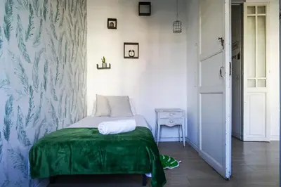 a bedroom with a bed with a green blanket on it at Ruzafa Apartment in Valencia