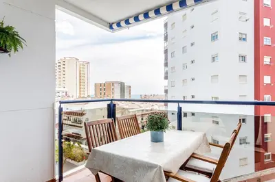 a table and chairs on a balcony with a view at Playa Valencia Residencial Sol y Mar Terraza con Vistas y Parking in Playa Pobla de Farnals