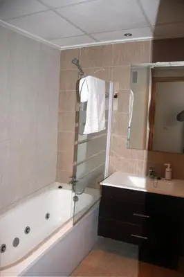 a bathroom with a tub and a sink and a shower at Holiday Apartments Malvarrosa Beach in Valencia