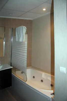 a bathroom with a tub and a sink and a bath tub at Holiday Apartments Malvarrosa Beach in Valencia