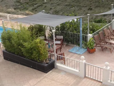 a patio with a tent and a table and chairs at LAS PALOMAS, appartement 3 chambres avec piscine in Turís